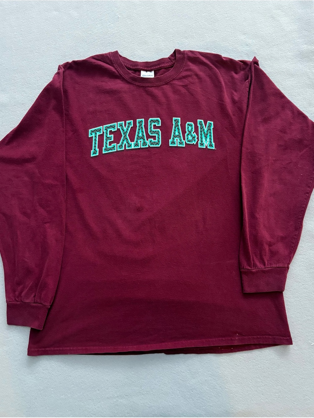 Gildan Texas A&M Long Sleeve Tee in Maroon with Teal Lettering